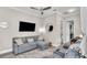 Living room features a ceiling fan, television, and comfortable seating at 3261 Fish Hawk Dr, Polk City, FL 33868