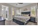 Comfortable main bedroom featuring a king-size bed, stylish furnishings, and access to an outdoor area at 3261 Fish Hawk Dr, Polk City, FL 33868