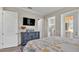 Spacious main bedroom includes a TV, dresser, and an ensuite bathroom with access to an outdoor area at 3261 Fish Hawk Dr, Polk City, FL 33868