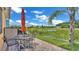 Patio area with seating, outdoor grill, and view of the pond at 3261 Fish Hawk Dr, Polk City, FL 33868
