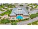 Aerial view of community pool and clubhouse with inviting lounge chairs surrounded by lush landscaping at 3261 Fish Hawk Dr, Polk City, FL 33868