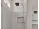 Elegant shower with rainfall shower head, recessed niche, and sleek tile design, offering a spa-like experience at 3261 Fish Hawk Dr, Polk City, FL 33868