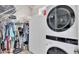 Walk-in closet featuring ample storage, shelving, and a washer and dryer at 3261 Fish Hawk Dr, Polk City, FL 33868