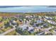 Community aerial view showcasing a desirable neighborhood with various houses and nearby lake at 3287 Red Tail Hawk Dr, Polk City, FL 33868