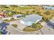 Aerial view of blue home, guest house, lush landscaping, and circular driveway at 3287 Red Tail Hawk Dr, Polk City, FL 33868