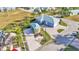 Expansive aerial view of blue house, with a detached garage, surrounded by well-manicured landscaping at 3287 Red Tail Hawk Dr, Polk City, FL 33868