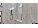 Modern bathroom with wavy tile shower featuring bench and handheld sprayer at 3287 Red Tail Hawk Dr, Polk City, FL 33868
