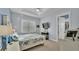 Bright bedroom featuring tray ceiling, large window, and closet access at 3287 Red Tail Hawk Dr, Polk City, FL 33868