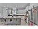 Spacious kitchen with white cabinets, stainless steel appliances, black countertops and large center island with seating at 3287 Red Tail Hawk Dr, Polk City, FL 33868