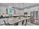 Modern kitchen with white cabinets, stainless steel appliances, and a large kitchen island at 3287 Red Tail Hawk Dr, Polk City, FL 33868