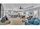 Bright living space featuring an open layout leading to a modern kitchen and dining area at 3287 Red Tail Hawk Dr, Polk City, FL 33868