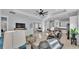 Open-concept living room with modern decor flowing into a spacious kitchen area at 3287 Red Tail Hawk Dr, Polk City, FL 33868