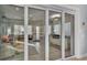 View of the sitting room through glass doors to adjoining kitchen and living room spaces at 3287 Red Tail Hawk Dr, Polk City, FL 33868