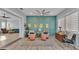 Sitting room with two chairs, two ottomans, and an accent wall, and open to other living spaces at 3287 Red Tail Hawk Dr, Polk City, FL 33868