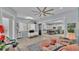 Bright sitting room is open to the kitchen, and features tile floors, plenty of sunlight, and an accent wall at 3287 Red Tail Hawk Dr, Polk City, FL 33868
