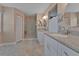 Bathroom featuring double sinks, granite countertops, and a walk-in shower with glass doors at 3487 Highland Fairways Blvd, Lakeland, FL 33810