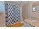 Bathroom featuring patterned shower curtain, light wood floors, and light colored walls at 3487 Highland Fairways Blvd, Lakeland, FL 33810