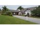 Community clubhouse featuring mature landscaping, covered front entry, and well-maintained grounds at 3487 Highland Fairways Blvd, Lakeland, FL 33810