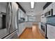 Well-lit kitchen with white cabinetry, stainless steel appliances, and a clear view into the dining area at 3487 Highland Fairways Blvd, Lakeland, FL 33810