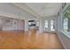 Open-concept living area with hardwood floors seamlessly connects to the kitchen and sunroom at 3487 Highland Fairways Blvd, Lakeland, FL 33810