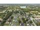 Aerial view of the neighborhood and surrounding landscape, featuring a peaceful lake at 3568 Jade Ln, Mulberry, FL 33860