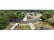 Aerial shot of the home situated on a tree lined street with a long driveway at 3568 Jade Ln, Mulberry, FL 33860