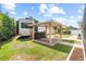 Backyard featuring lush lawn, swing set with covered area, and parked RV at 3568 Jade Ln, Mulberry, FL 33860