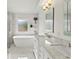 Bright, airy bathroom with white marble, soaking tub, and double sink vanity at 3568 Jade Ln, Mulberry, FL 33860