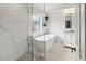 Luxurious bathroom featuring a glass enclosed shower and standalone soaking tub at 3568 Jade Ln, Mulberry, FL 33860