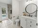 Updated bathroom featuring glass shower and stylish vanity with dark hardware at 3568 Jade Ln, Mulberry, FL 33860