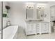 Well-lit bathroom with modern fixtures, dual sinks, and stylish vanity at 3568 Jade Ln, Mulberry, FL 33860