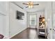 This bright bedroom has hardwood floors, a ceiling fan, and a window with bright sunlight at 3568 Jade Ln, Mulberry, FL 33860