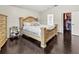 Elegant bedroom with hardwood floors showcasing a walk-in closet and ensuite bathroom at 3568 Jade Ln, Mulberry, FL 33860