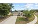 Attractive one-story home with a two-car garage, mature trees, and lush landscaping enhancing curb appeal at 3568 Jade Ln, Mulberry, FL 33860