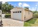 A spacious detached garage featuring a white door at 3568 Jade Ln, Mulberry, FL 33860