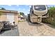 View of a house with a garage and parked RV on a paved lot at 3568 Jade Ln, Mulberry, FL 33860