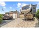 Home exterior featuring detached garage and RV parking on paved drive at 3568 Jade Ln, Mulberry, FL 33860
