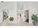 Hallway with views of the kitchen, living areas, tile flooring, and neutral color scheme at 3568 Jade Ln, Mulberry, FL 33860