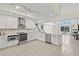 This kitchen has an island, stainless steel appliances, a tile backsplash, and bright lighting at 3568 Jade Ln, Mulberry, FL 33860