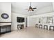 Open living room with an adjacent fireplace and views into the kitchen at 3568 Jade Ln, Mulberry, FL 33860
