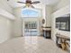 A bright living room with pool views, a fireplace, and a ceiling fan at 3568 Jade Ln, Mulberry, FL 33860