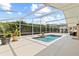 Inviting pool area features a screened enclosure, serene water fountain, and ample space for outdoor living at 3568 Jade Ln, Mulberry, FL 33860