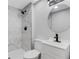 Stylish bathroom with modern vanity, round mirror, and walk-in shower at 3601 Avenue R Nw, Winter Haven, FL 33881