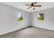 Bright bedroom features plush carpeting, modern ceiling fan and lots of natural light at 3601 Avenue R Nw, Winter Haven, FL 33881