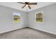 Bright bedroom features plush carpeting, modern ceiling fan and lots of natural light at 3601 Avenue R Nw, Winter Haven, FL 33881