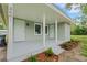 Inviting covered porch with a fresh coat of grey paint and two entry doors leading into the home at 3601 Avenue R Nw, Winter Haven, FL 33881