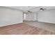 An open-concept living room with wood-look floors and carpet, illuminated by overhead ceiling fans at 3601 Avenue R Nw, Winter Haven, FL 33881