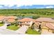 Aerial view of a community with well-maintained lawns and tile roofs with a pond at 3980 Sunset Lake Dr, Lakeland, FL 33810
