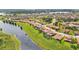 Scenic aerial view showcasing a lakeside community with lush green spaces and a variety of home designs at 3980 Sunset Lake Dr, Lakeland, FL 33810