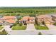 Aerial view of a community with well-maintained lawns and tile roofs near a pond at 3980 Sunset Lake Dr, Lakeland, FL 33810